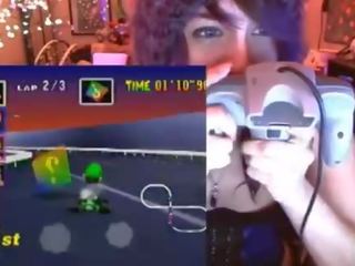 Geek young woman cums playing Mario Kart